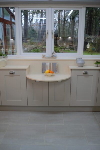 Kitchen windows with painted shaker cabinets and quartz worktops