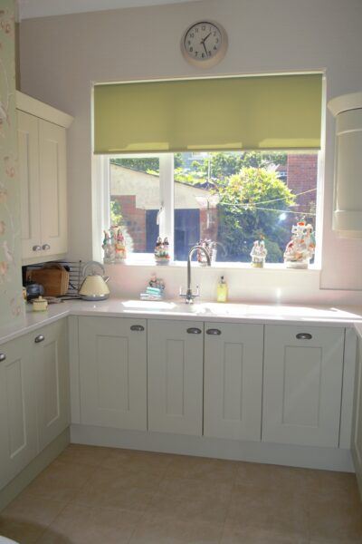 Sunlit window accentuates cream shaker cabinets in this Cavendish Kitchens' design