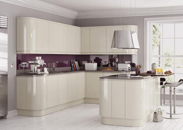 A Cavendish designed kitchen with curved cabinets and a sleek white gloss finish