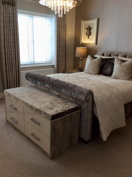 : Luxurious bedroom featuring a crushed velvet bed frame with matching furniture at the foot of the bed. Chest of drawers adorned with matching velvet on the top surface, all part of the elegant Cavendish designed bedroom furniture collection.