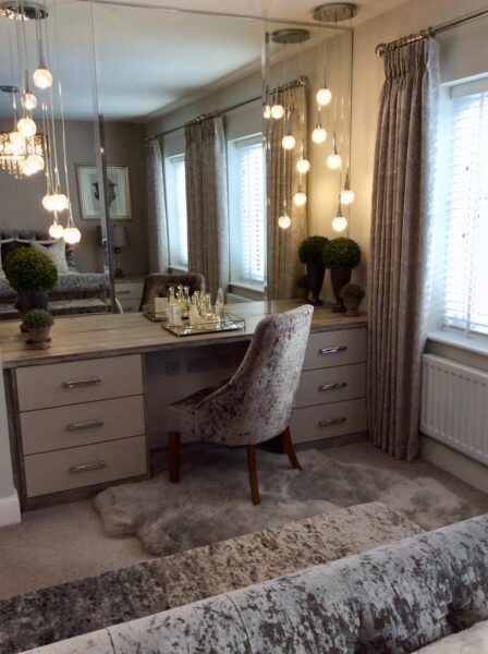 Built in dressing table with large mirrors and ball string lights designed by Cavendish Bedrooms