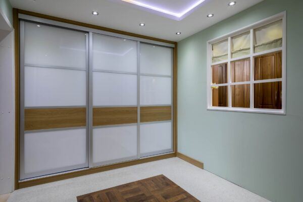 Sliding Panel Wardrobe with Wood and Glass Panelling installed by Cavendish Bedrooms, Newcastle 